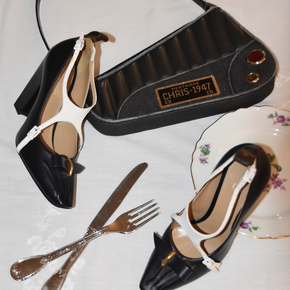 Vintage handbag and shoes arranged with tableware