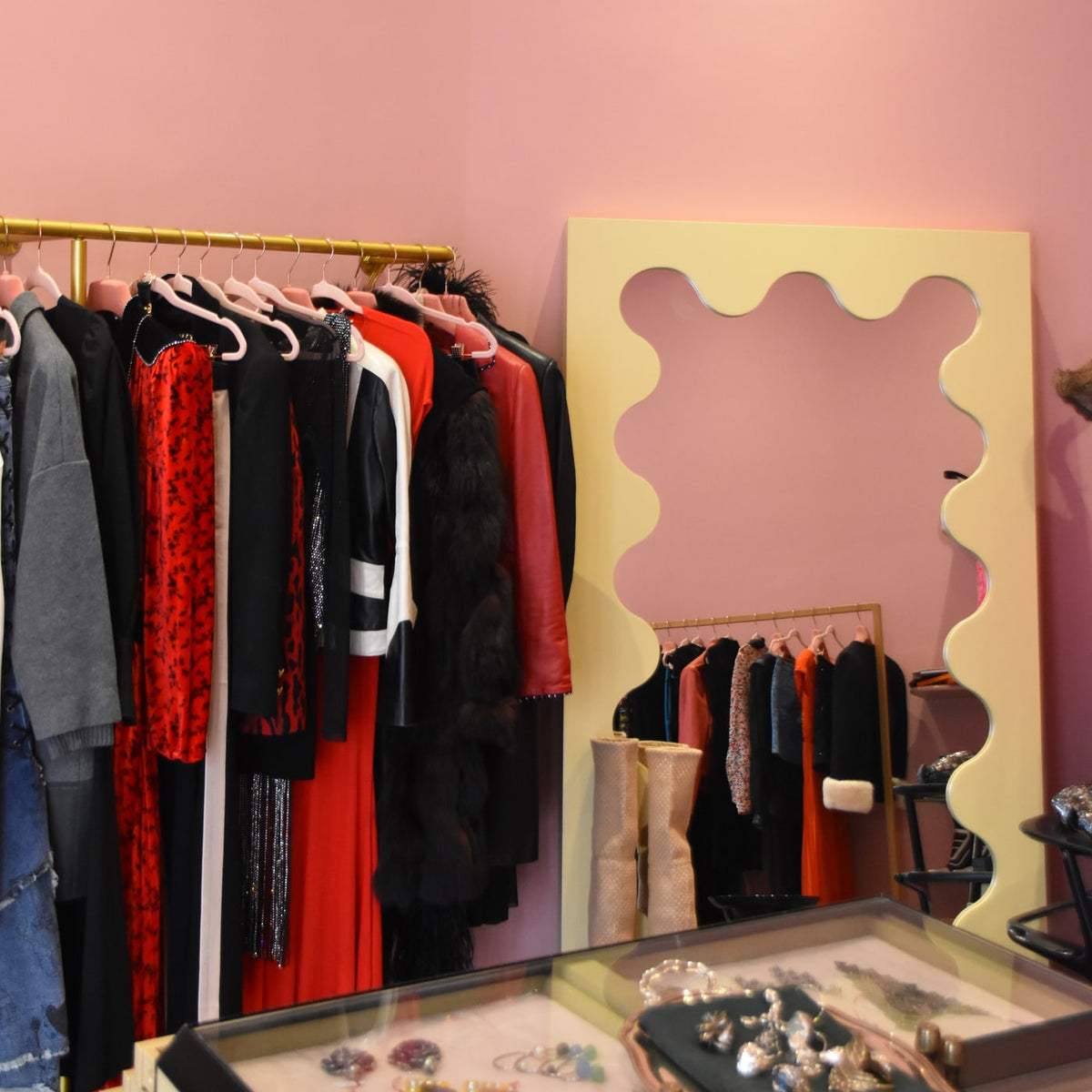 Pink walls, clothing and jewellery displays inside the Gizeye Milan boutique