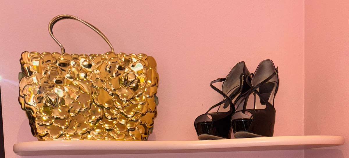 Vintage bags and shoes on pink shelves at the Gizeye Milan boutique