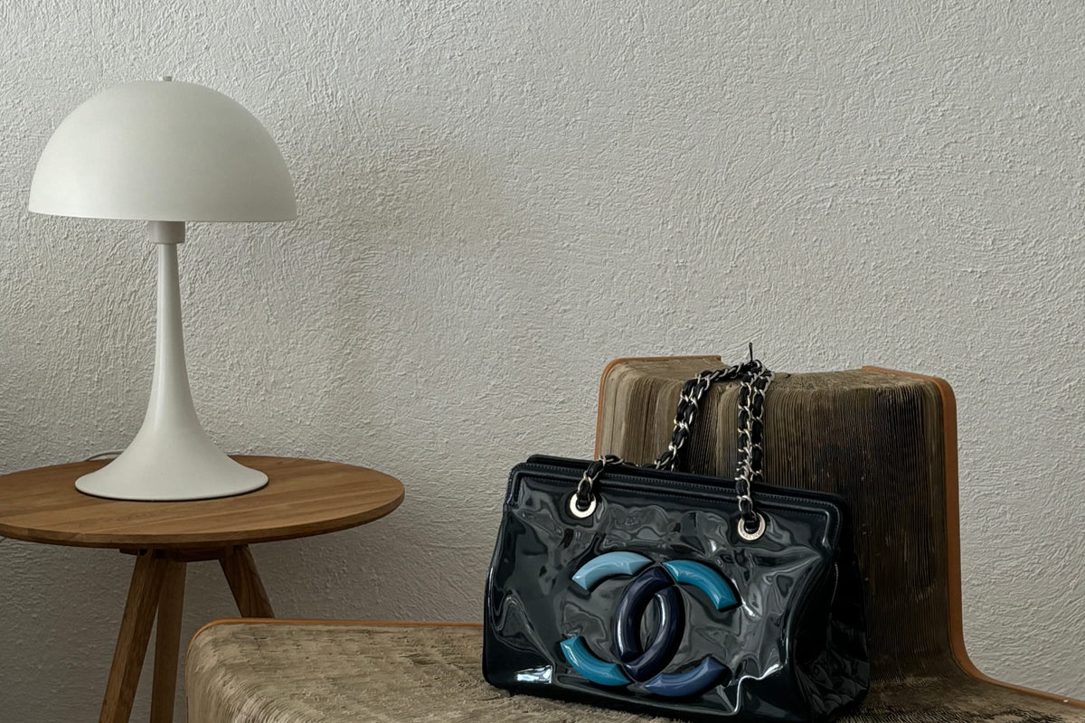 Sculptural chair, white table lamp and vintage handbag styled by Gizeye