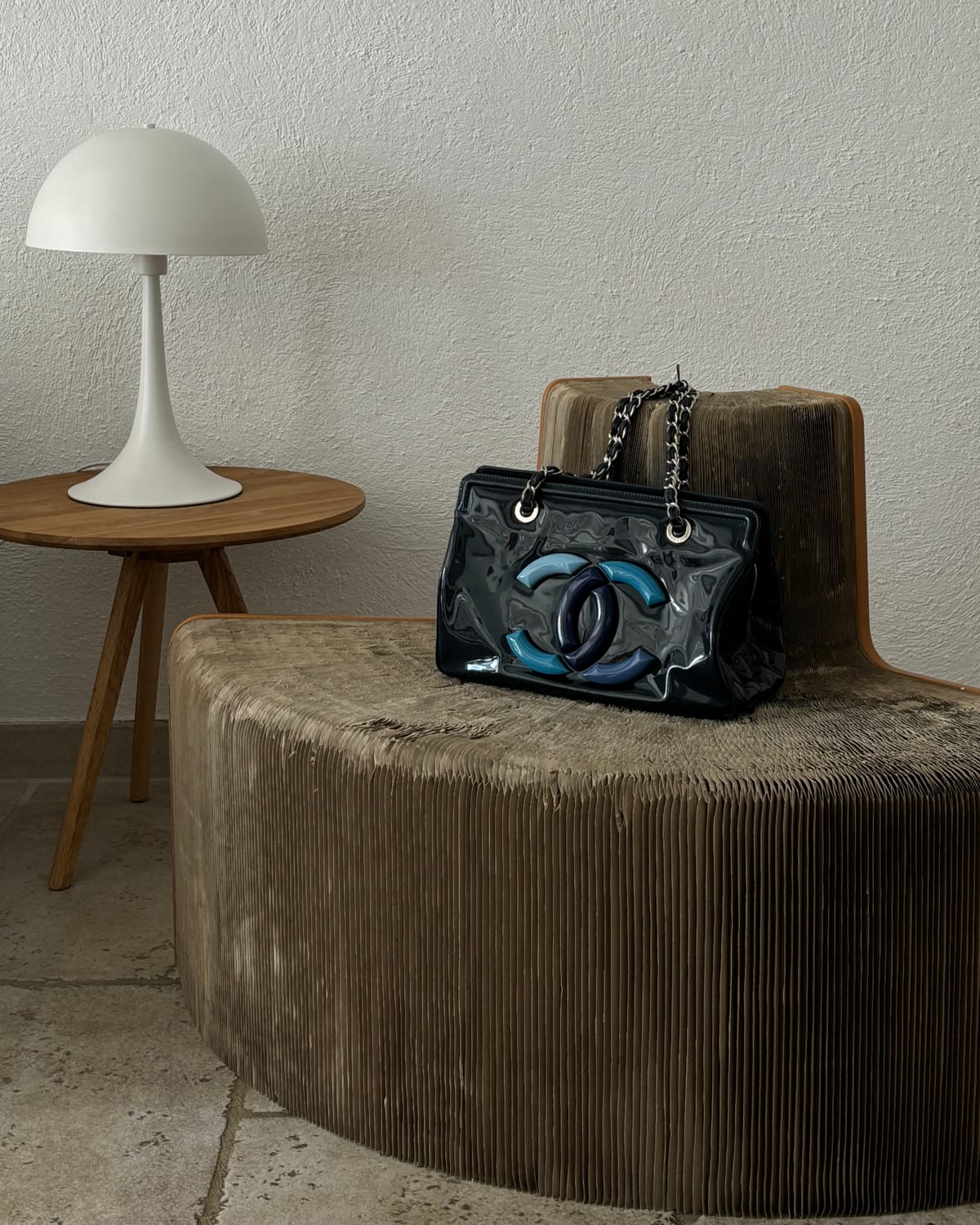 Sculptural chair, white table lamp and vintage handbag styled by Gizeye