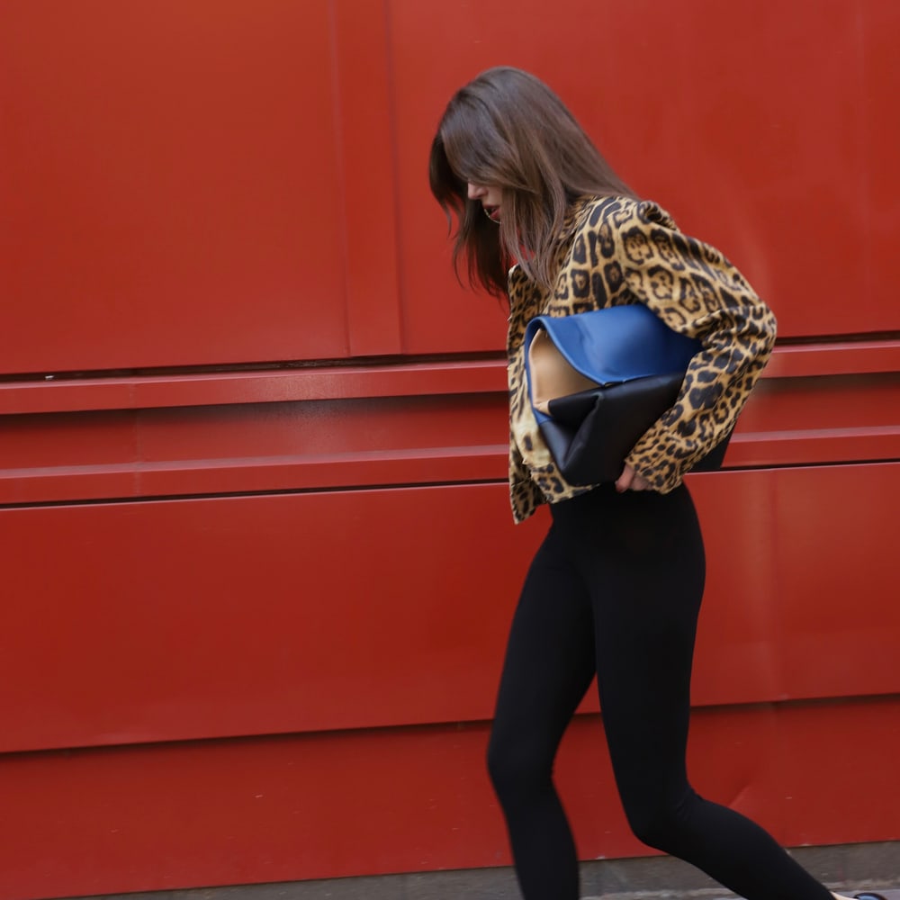 Vintage animal-print outfit styled with a blue handbag