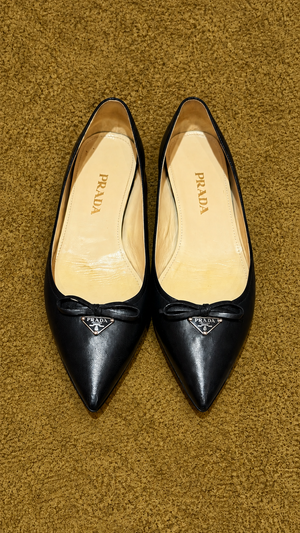 Prada pointed bow ballet flats — muted gold background