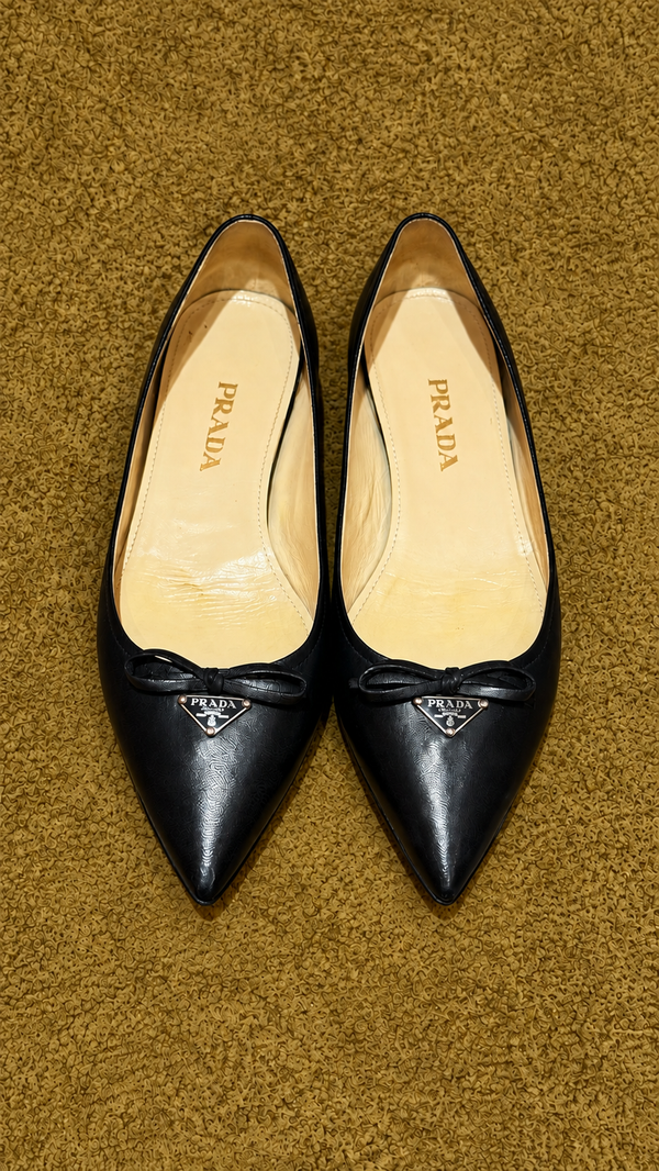Prada pointed bow ballet flats — muted gold background