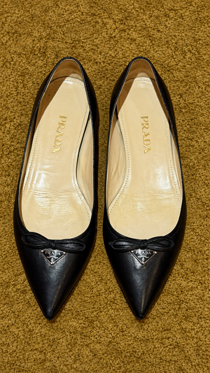 Prada ballet flats — detail view on muted gold background
